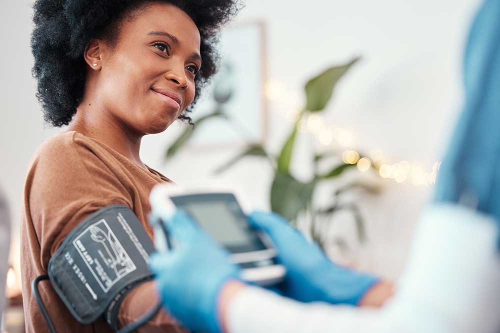 Person getting their blood pressure checked by their gp